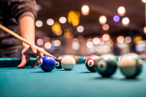 a group of young people came to play billiards and in the young hands was a cane and layers. a group of young people came to play billiards and in the young hands was a cane and layers. The concept of playing billiards in the company pool break stock pictures, royalty-free photos & images