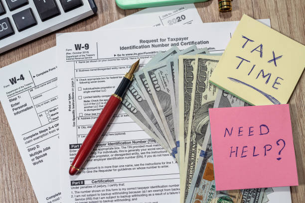 istock Form w4, w9 is empty to fill with money dollars on the table. 1370683719
