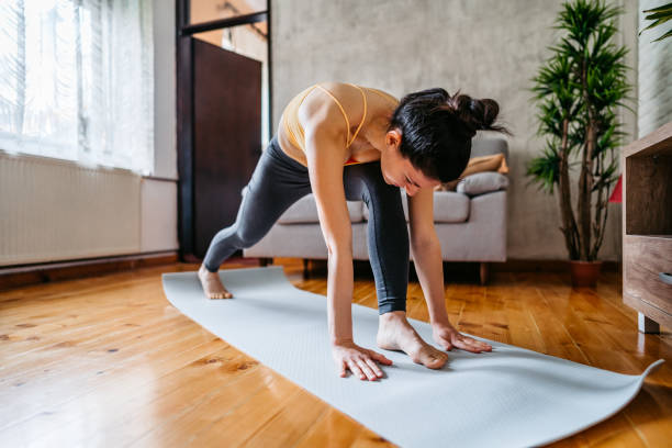 istock Young Woman Practicing Yoga At Home 1370684475