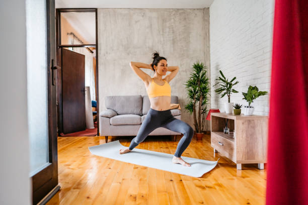 istock Young Woman Practicing Yoga At Home 1370685295