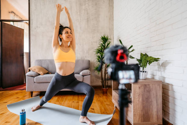 istock Woman Vlogger Practicing Yoga From Home 1370685369