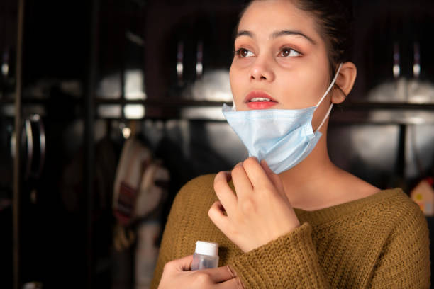 istock Young woman takes off protective face and taking a deep breath. 1370685388