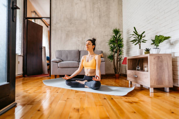 istock Young Woman Practicing Yoga In Lotus Position 1370685647