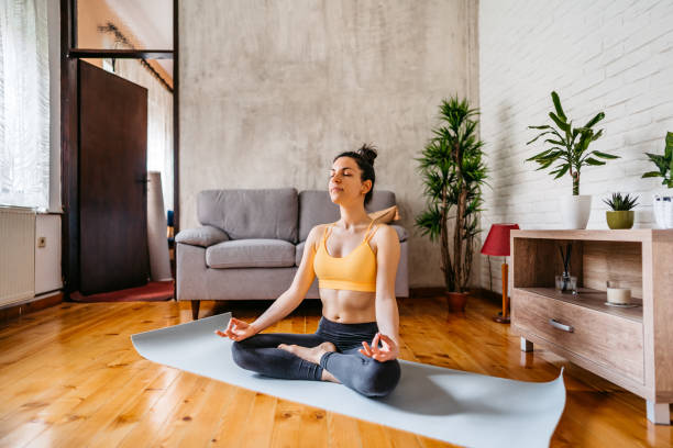 istock Young Woman Practicing Yoga In Lotus Position 1370685921
