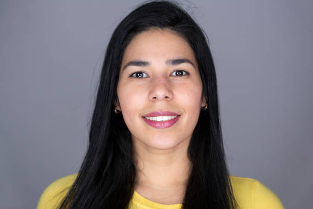 istock Young beautiful latin lady headshot with a big smile while standing in front position and looking up to the camera 1370686046