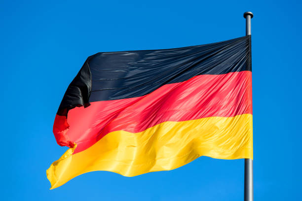 istock a shiny german flag in the wind 1370687322