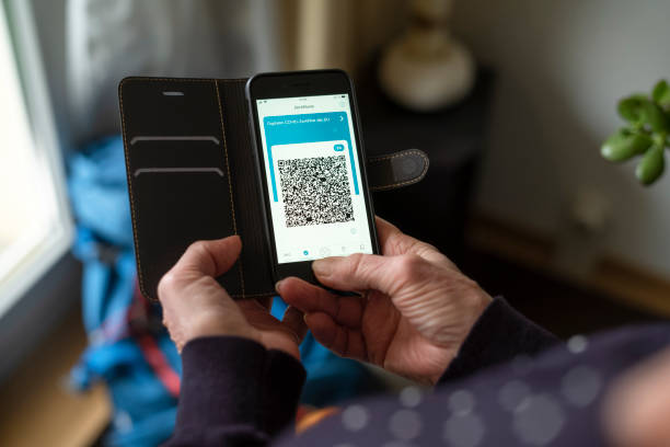 istock Silversurfer holds Smartphone with a digital corona certificate on screen. Travel while COVID-19. 1370687645