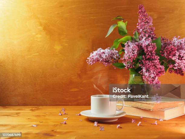 A Cup Of Hot Coffee Or Tea On A Wooden Table And A Vase With A Bouquet Of Lilac Copy Space Stock Photo - Download Image Now