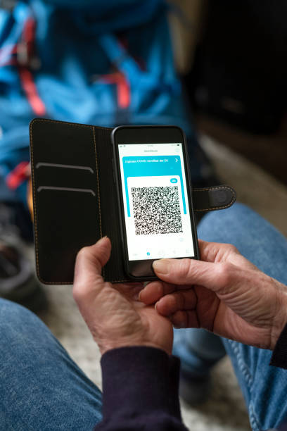 istock Silversurfer holds Smartphone with a digital corona certificate on screen. Travel while COVID-19. 1370687775