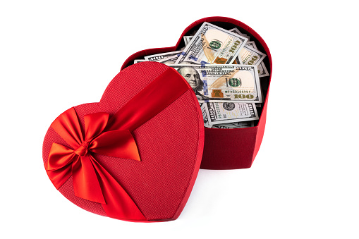 Hundred Dollar Bills Forming A Heart Shape On A White Background