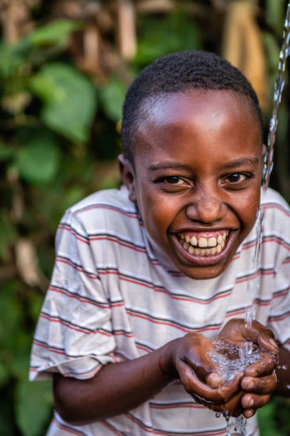 istock African young boy drinking fresh water, East Africa 1370690295