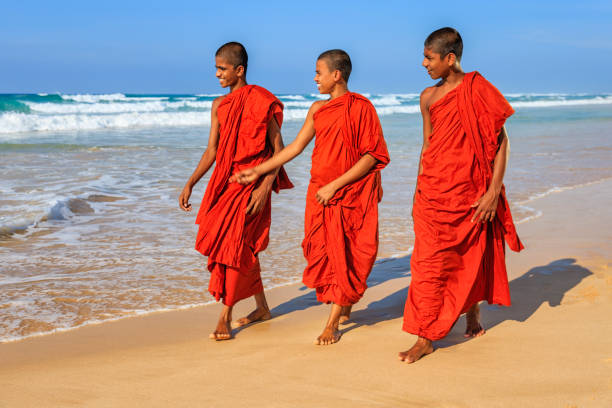 istock Sri Lankan young buddhist monks walking on the beach, Ceylon 1370690539