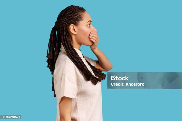 Side View Of Woman Wants To Scream Covers Mouth With Palm Stares At Something Terrible Stock Photo - Download Image Now