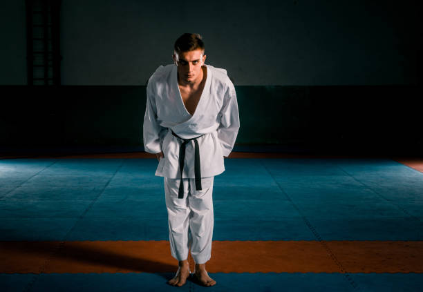 istock Young man is practicing martial arts in sport gym 1370691868