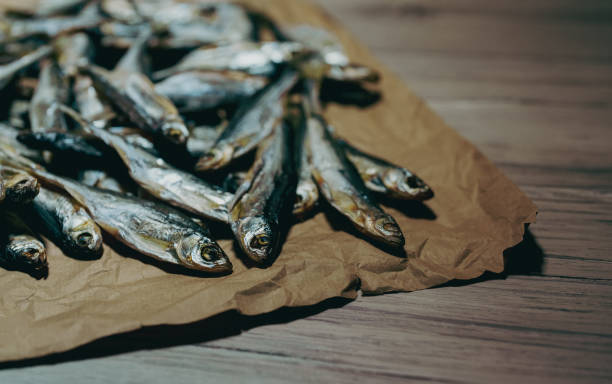 Lots of sun dried fish on the paper. stock photo