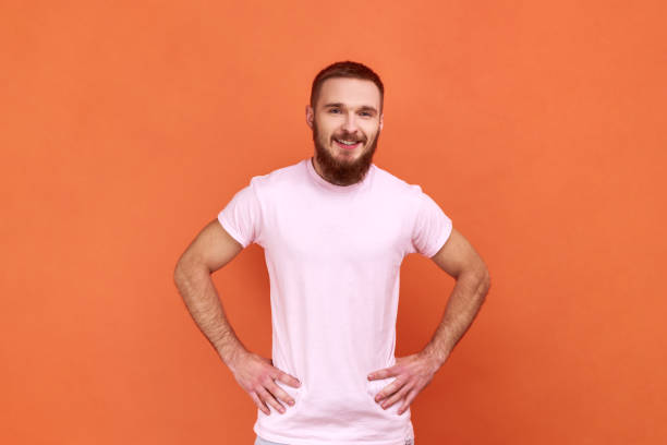 istock Man standing with hands on hips, looking at camera, expressing positive emotions, being in good mood 1370692150