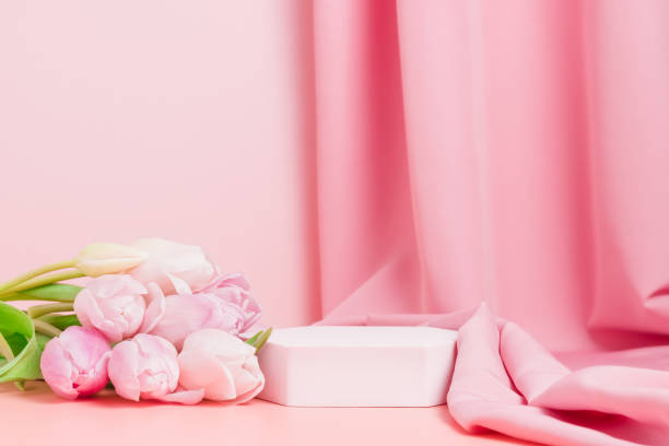 istock Podium with pink tulips and textile fabric drape at the background 1370693609