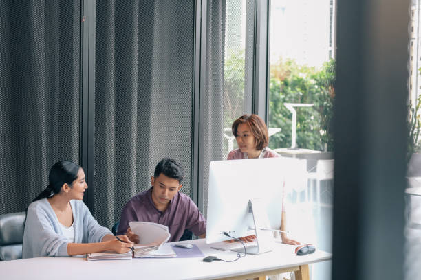 istock Mature woman helps colleagues 1370693626