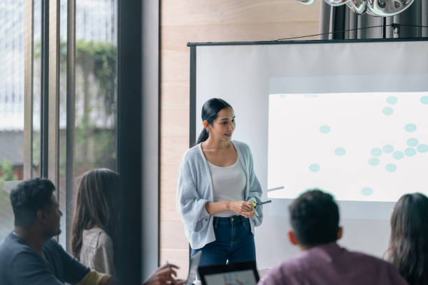 istock Mature woman leads business presentation 1370693671