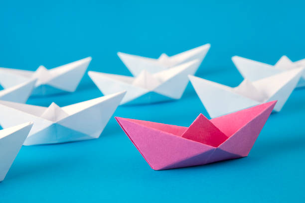 istock Red Paper Boat Leading Other Boats 1370694811