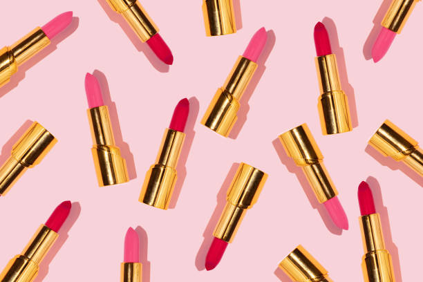 istock Creative pattern made with red and pink golden lipsticks on pastel pink background. Retro style aesthetic. Trendy and fashion makeup idea. Romantic concept. 1370694837