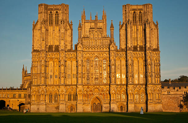 The west front of 800 year old The Cathedral of St. Andrew at Wells, bathed in a golden late evening light;  showing one of Europe's finest displays of medieval statuary