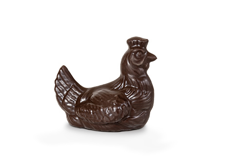 Side view of delicious Belgian Chocolate Easter Chicken isolated on white background. Dark shiny chocolate. Easter animal figure.