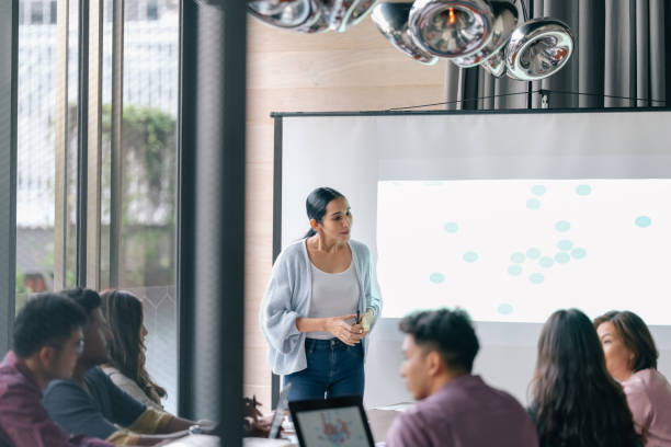 istock Mature woman leads business presentation 1370696842