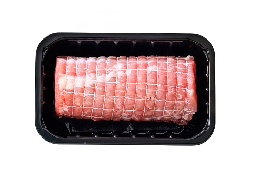 pork roulade in black plastic tray isolated on white with clipping path