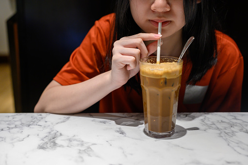 Asian Chinese girl drinking iced coffee