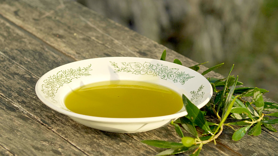 Olive oil is poured into a beautiful plate.