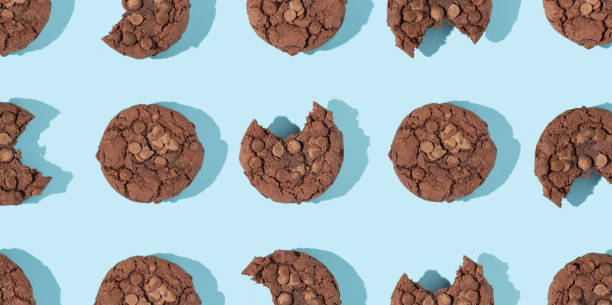 istock Creative pattern made with chocolate chip cookies on pastel blue background. Happy sweet optimistic life idea. Fun food or dessert concept. Spring or summer layout. 1370700284