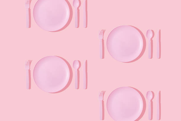 istock Creative pattern made with pastel pink plate, spoon, fork and knife on pastel pink background. Minimal surreal breakfast idea or food restaurant concept. Vintage aesthetic 80s or 90s fashion background. 1370701109