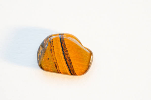macro mineral stone tiger's eye on a white background close-up