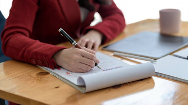 istock Businesswoman analyzing chart and graph investment information in office. 1370701983
