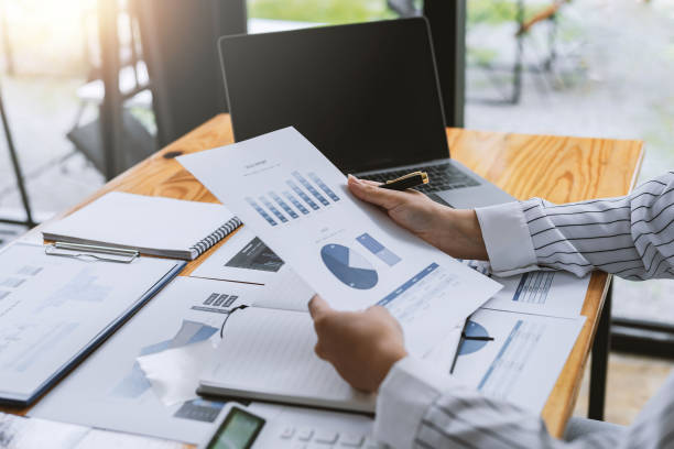 istock Businesswoman analyzing chart and graph investment information in office. 1370702056