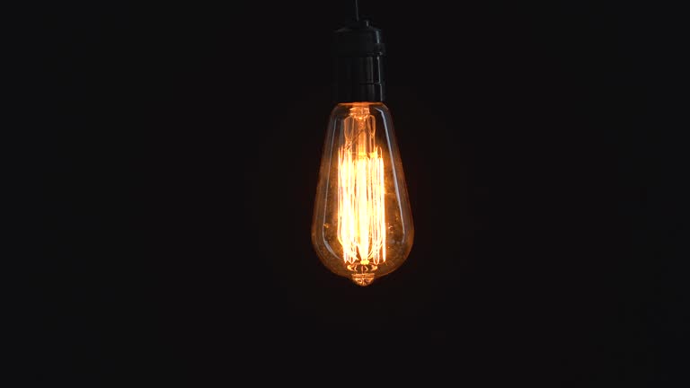 Incandescent light bulb glowing in studio