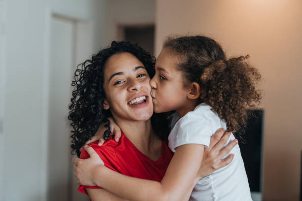 istock Sisters hugging and having fun at home 1370703395