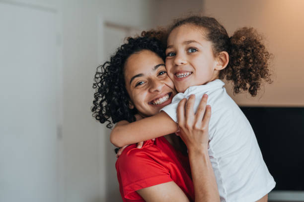 istock Sisters hugging and having fun at home 1370703397