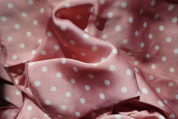 istock Soft folds on satin fabric with pink and white polka dot pattern 1370704365