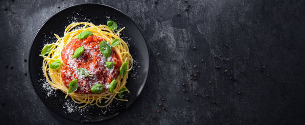 istock Composition with a plate of spaghetti bolognese 1370704739