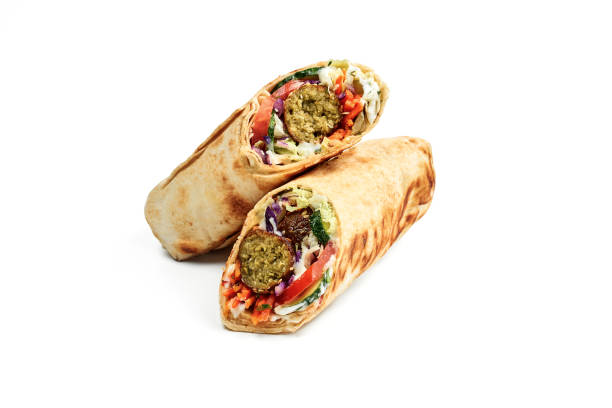 Vegetarian shawarma with falafel, vegetables and white sauce isolated on a white background