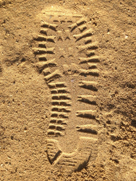 istock Boot print in the gold colored sand 1370706119