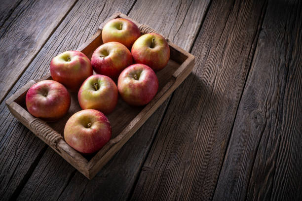 istock Red apples crate wooden box on dark wood board rustic table leaving copy space 1370706606