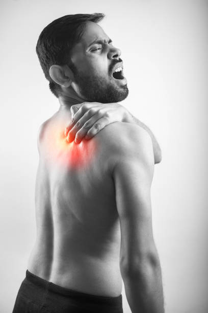 istock man holding his scapula pain point with red highlight glow 1370706757