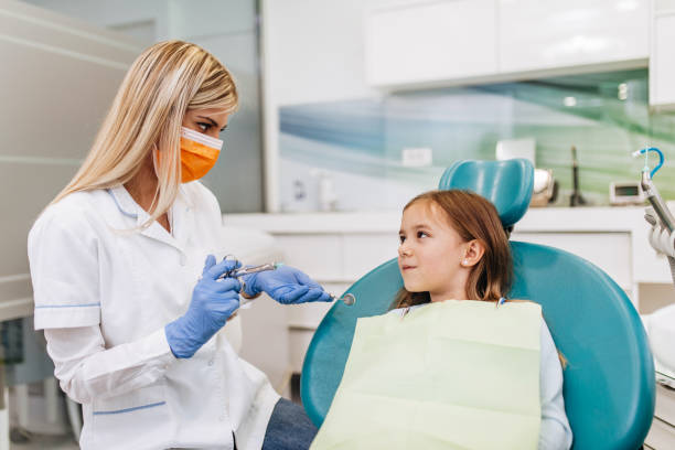 istock Girl at dentist office 1370708664