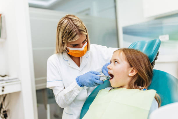 istock Girl at dentist office 1370708684