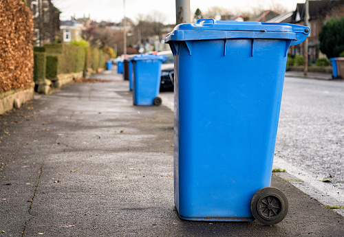 Recycling bins put on the pavement for collection outside houses in Glasgow, Scotland.