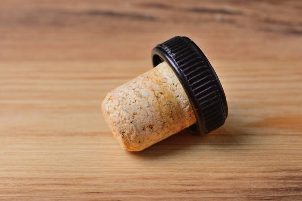 bottle stopper close-up on the background of a wooden surface bottle stopper close-up on the background of a wooden surface cork stopper stock pictures, royalty-free photos & images
