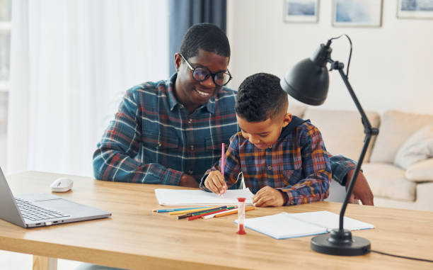 istock Drawing lessons. African american father with his young son at home 1370710600